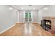 Bright living room with a fireplace, hardwood floors and a double door leading to a balcony at 2404 Northlake Ct, Atlanta, GA 30345