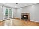 Bright living room with a fireplace, hardwood floors and a double door leading to a balcony at 2404 Northlake Ct, Atlanta, GA 30345
