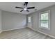 Bedroom with ceiling fan, grey walls, light hardwood floors, door and window at 5825 Rolling Oaks Dr, Cumming, GA 30040