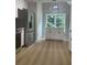 Bright kitchen featuring stainless steel appliances and light wood-look floors at 5825 Rolling Oaks Dr, Cumming, GA 30040