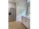 Kitchen view showcasing stainless steel refrigerator and white cabinetry at 5825 Rolling Oaks Dr, Cumming, GA 30040