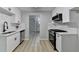 Modern kitchen with white cabinetry, stainless steel appliances, and granite countertops at 5825 Rolling Oaks Dr, Cumming, GA 30040
