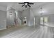Large open-concept living space featuring luxury vinyl plank flooring and modern lighting at 5825 Rolling Oaks Dr, Cumming, GA 30040