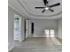 Spacious main bedroom with tray ceilings, fan, and ensuite bathroom at 5825 Rolling Oaks Dr, Cumming, GA 30040