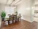 Elegant dining room with hardwood floors, natural light, chandelier, and seating for six at 2144 Beacon Crest Dr, Buford, GA 30519