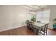Bright dining room featuring hardwood floors, natural light from the window, and a contemporary chandelier at 2144 Beacon Crest Drive, Buford, GA 30519
