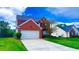 Charming red brick home with a well-maintained lawn and a two-car garage at 2144 Beacon Crest Drive, Buford, GA 30519