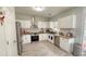Well-lit kitchen with stainless steel appliances, granite countertops, and tile floors at 2144 Beacon Crest Drive, Buford, GA 30519