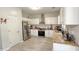 Modern kitchen with stainless steel appliances, granite countertops, and white cabinets at 2144 Beacon Crest Drive, Buford, GA 30519