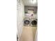 Functional laundry room with modern appliances, cabinets, and tiled flooring at 2144 Beacon Crest Drive, Buford, GA 30519