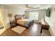 Spacious main bedroom with trey ceiling, hardwood floors, large window, and access to the ensuite bathroom at 2144 Beacon Crest Drive, Buford, GA 30519