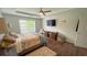 Comfortable main bedroom featuring hardwood floors, a ceiling fan, and a sun-filled window at 2144 Beacon Crest Drive, Buford, GA 30519