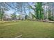 An expansive backyard with lush green grass and surrounding mature trees offers privacy at 2198 Star Mist Sw Dr, Atlanta, GA 30311