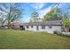 A white brick house with a large backyard, perfect for outdoor activities and relaxation at 2198 Star Mist Sw Dr, Atlanta, GA 30311