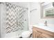 Stylish bathroom showcasing a herringbone-tiled shower, modern vanity, and sleek fixtures for a spa-like feel at 2198 Star Mist Sw Dr, Atlanta, GA 30311