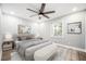 Serene main bedroom featuring a comfortable bed, bench, and plenty of natural light for relaxation at 2198 Star Mist Sw Dr, Atlanta, GA 30311