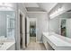 Bright bathroom featuring double vanity, walk-in closet, and tile flooring at 2325 Walnut Grove Way, Suwanee, GA 30024