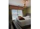 Bedroom with bed, window and decorative chandelier at 2325 Walnut Grove Way, Suwanee, GA 30024