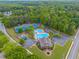 Aerial view of community amenities: pool, tennis courts, playground, clubhouse, and ample parking at 2325 Walnut Grove Way, Suwanee, GA 30024