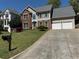 Traditional two-story home featuring brick and siding, attached two-car garage, and a well-manicured front yard at 2325 Walnut Grove Way, Suwanee, GA 30024