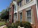 Close-up of the home's exterior featuring a brick facade, neutral siding, and decorative shutters at 2325 Walnut Grove Way, Suwanee, GA 30024