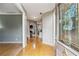Entryway with hardwood floors, view of the open floor plan, and decorative glass on the front door at 2325 Walnut Grove Way, Suwanee, GA 30024