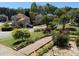 View of the neighborhood with well-maintained landscaping, sidewalks, and colorful flower beds in the front yard at 2325 Walnut Grove Way, Suwanee, GA 30024