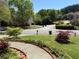 View of front yard featuring landscaped flower beds and decorative walkway at 2325 Walnut Grove Way, Suwanee, GA 30024