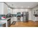 Bright kitchen with stainless steel appliances, granite countertops, and subway tile backsplash at 2325 Walnut Grove Way, Suwanee, GA 30024