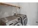 Practical laundry room equipped with modern washer and dryer units for convenient chore management at 2325 Walnut Grove Way, Suwanee, GA 30024