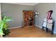 Neutral-toned living room featuring hardwood floors, bookshelf, and a plant at 2325 Walnut Grove Way, Suwanee, GA 30024
