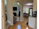 Open-concept living area showcasing hardwood floors, an arched doorway, fireplace, and stairs to the second level at 2325 Walnut Grove Way, Suwanee, GA 30024