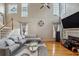 Spacious living room showcasing a cozy seating area, fireplace, large windows and a staircase at 2325 Walnut Grove Way, Suwanee, GA 30024