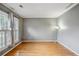 Well-lit living room with hardwood floors and large windows letting in natural light at 2325 Walnut Grove Way, Suwanee, GA 30024