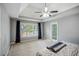 Serene main bedroom featuring plush carpet, ceiling fan, and abundant natural light at 2325 Walnut Grove Way, Suwanee, GA 30024