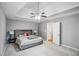 Spacious main bedroom featuring a tray ceiling, ceiling fan, and neutral tones at 2325 Walnut Grove Way, Suwanee, GA 30024