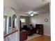 Bright office featuring a large desk, arched doorways, and a ceiling fan providing a comfortable workspace at 2325 Walnut Grove Way, Suwanee, GA 30024