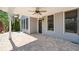 Covered back patio featuring stone flooring, a ceiling fan, and views of the surrounding landscape at 3709 Baxley Ridge Dr, Suwanee, GA 30024