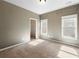 Neutral bedroom with carpet and two windows provides a calm retreat at 3709 Baxley Ridge Dr, Suwanee, GA 30024