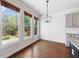 Sunlit dining area with views of the backyard, pendant light, hardwood floors, and white shiplap wall at 3709 Baxley Ridge Dr, Suwanee, GA 30024