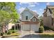 Charming two-story home featuring a brick and gray facade with a two-car garage and manicured landscaping at 3709 Baxley Ridge Dr, Suwanee, GA 30024