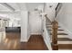 Inviting foyer with hardwood floors, staircase, and view into a spacious kitchen with a large island at 3709 Baxley Ridge Dr, Suwanee, GA 30024