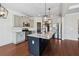 Well-equipped kitchen with gray cabinets, granite countertops, stainless steel appliances, and a center island sink at 3709 Baxley Ridge Dr, Suwanee, GA 30024