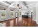 Bright living room with hardwood floors, coffered ceilings, and an open-concept design to the kitchen at 3709 Baxley Ridge Dr, Suwanee, GA 30024