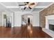 Open living space with hardwood floors flows to the kitchen and staircase, complemented by a cozy fireplace at 3709 Baxley Ridge Dr, Suwanee, GA 30024
