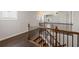 Upstairs landing with hardwood floors, decorative railing, and natural light from a window at 3709 Baxley Ridge Dr, Suwanee, GA 30024