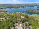 Scenic aerial view with lush green trees surrounding homes near a blue lake at 7665 Golden Sands Dr, Cumming, GA 30041