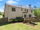 View of backyard featuring a wooden deck, lush lawn, and partial fence at 7665 Golden Sands Dr, Cumming, GA 30041