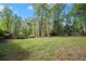 Beautiful backyard with lush greenery, mature trees, and a well-maintained lawn, creating a serene outdoor space at 7665 Golden Sands Dr, Cumming, GA 30041