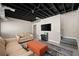 Basement area showcasing a comfortable seating arrangement with a sofa, love seat, and ottoman centered around a flat-screen TV at 7665 Golden Sands Dr, Cumming, GA 30041